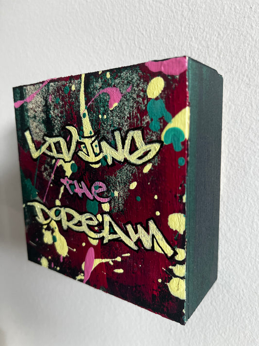 Colorful cube with abstract design and text on a white background