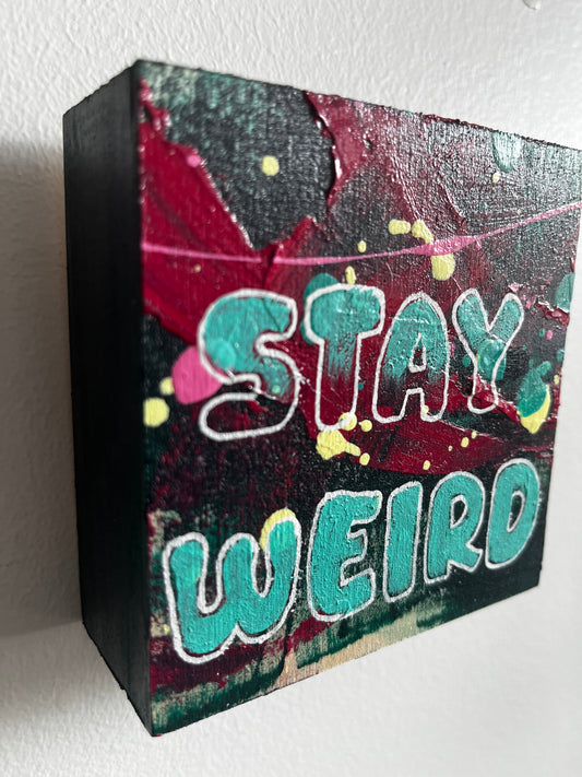 Colourful square painting with 'Stay Weird' text on a white background
