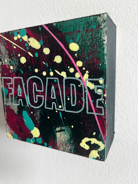 Colorful box with 'FACADE' branding on a white background