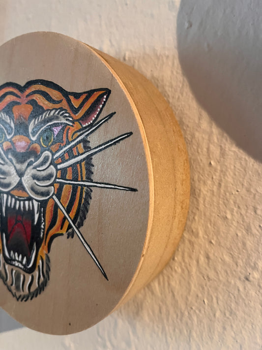 Wood panel painting with a colourful traditional tattoo design of a tiger on a textured beige background