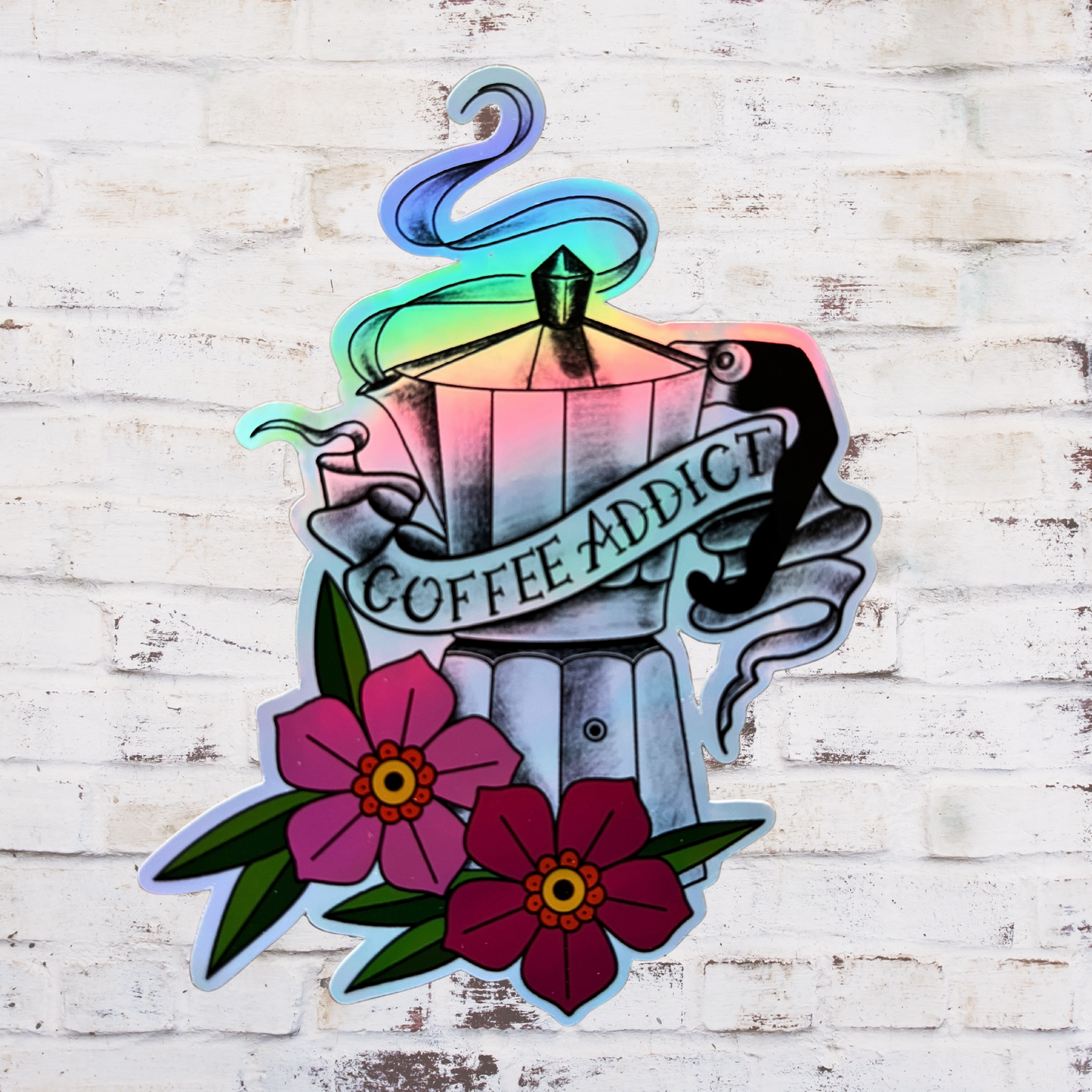 Colorful tattoo-style design with coffee pot, flowers, and 'Coffee Addict' text on a wooden background.