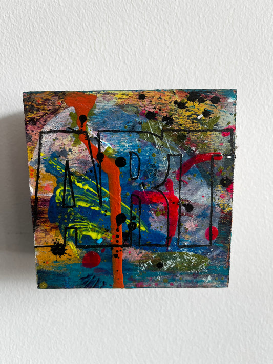 Abstract painting with vibrant colors on a textured white wall