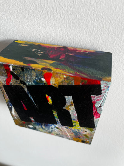 Abstract art piece with geometric shapes on a white wall