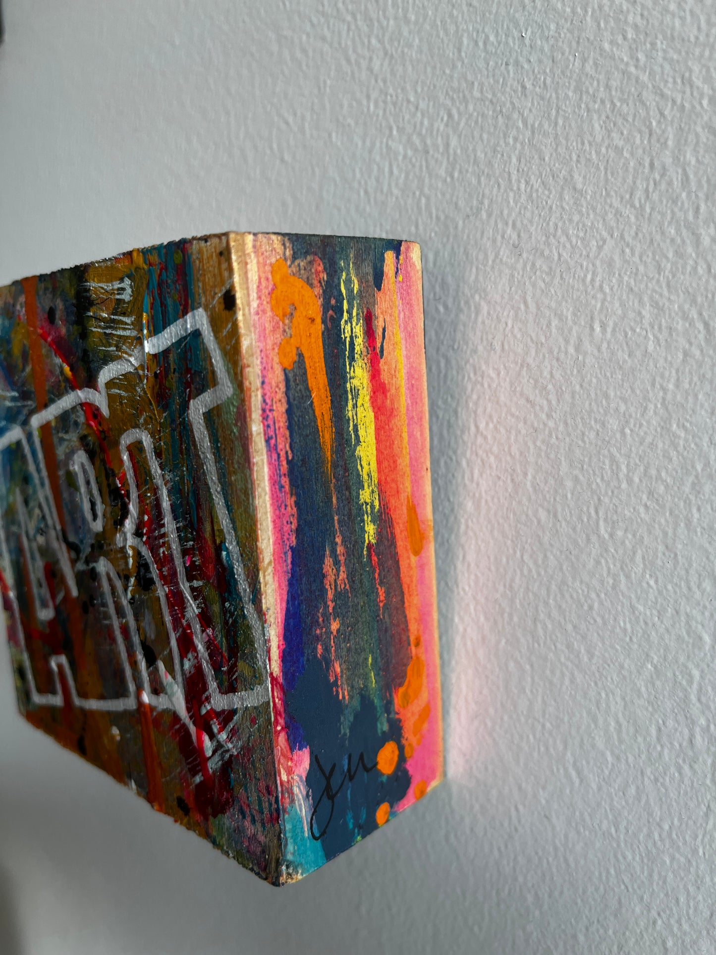 Colorful abstract painting on a textured wall