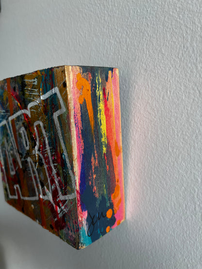 Colorful abstract painting on a textured wall