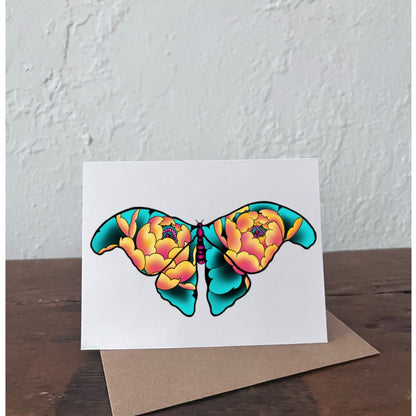 Greeting card with a colorful butterfly design on a wooden surface and light gray background