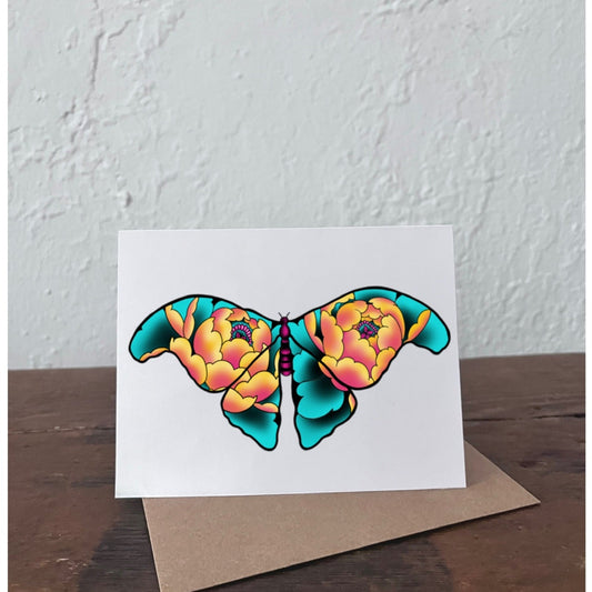 Greeting card with a colorful butterfly design on a wooden surface and light gray background