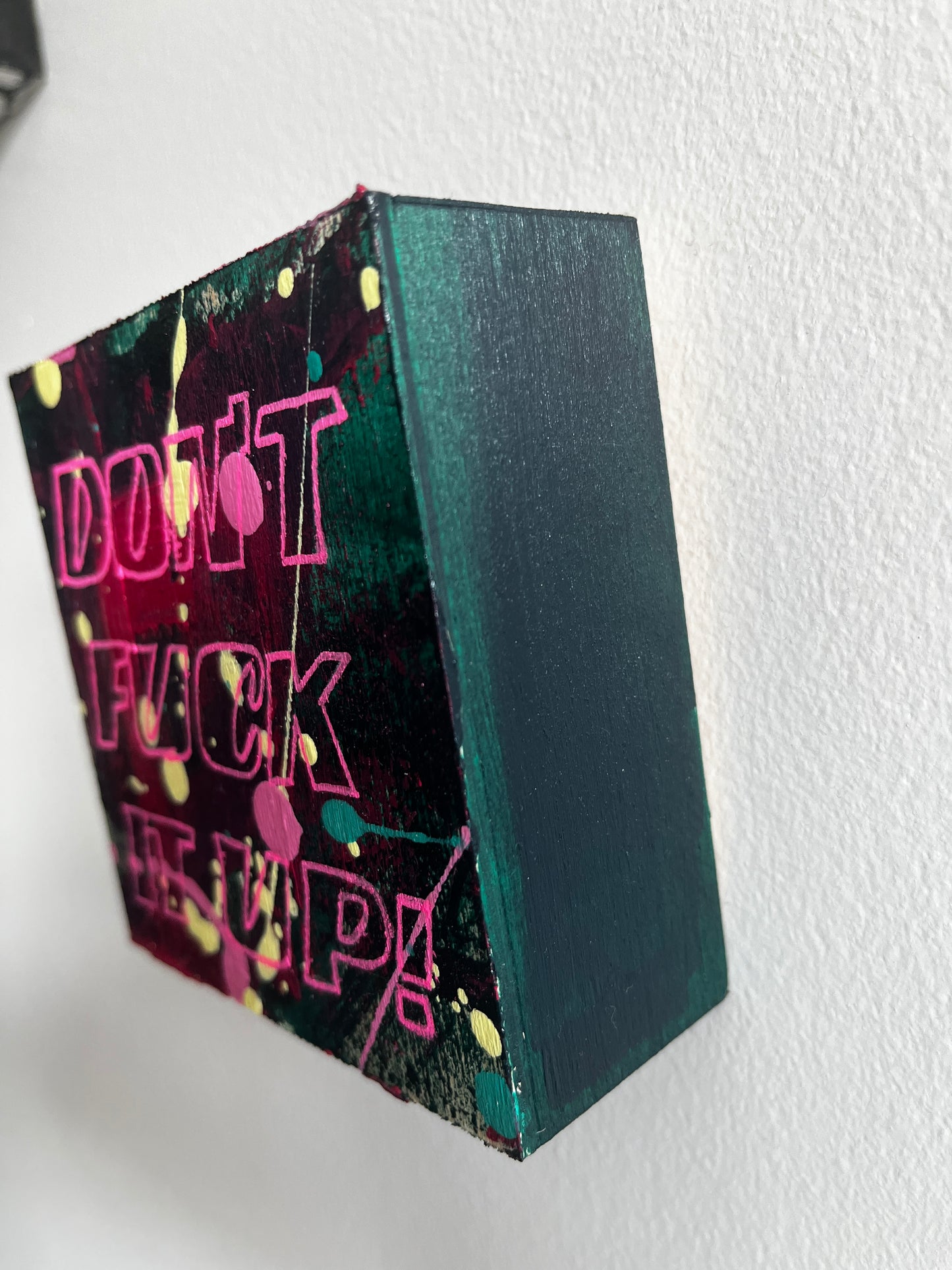 Black box with colorful text on a white background