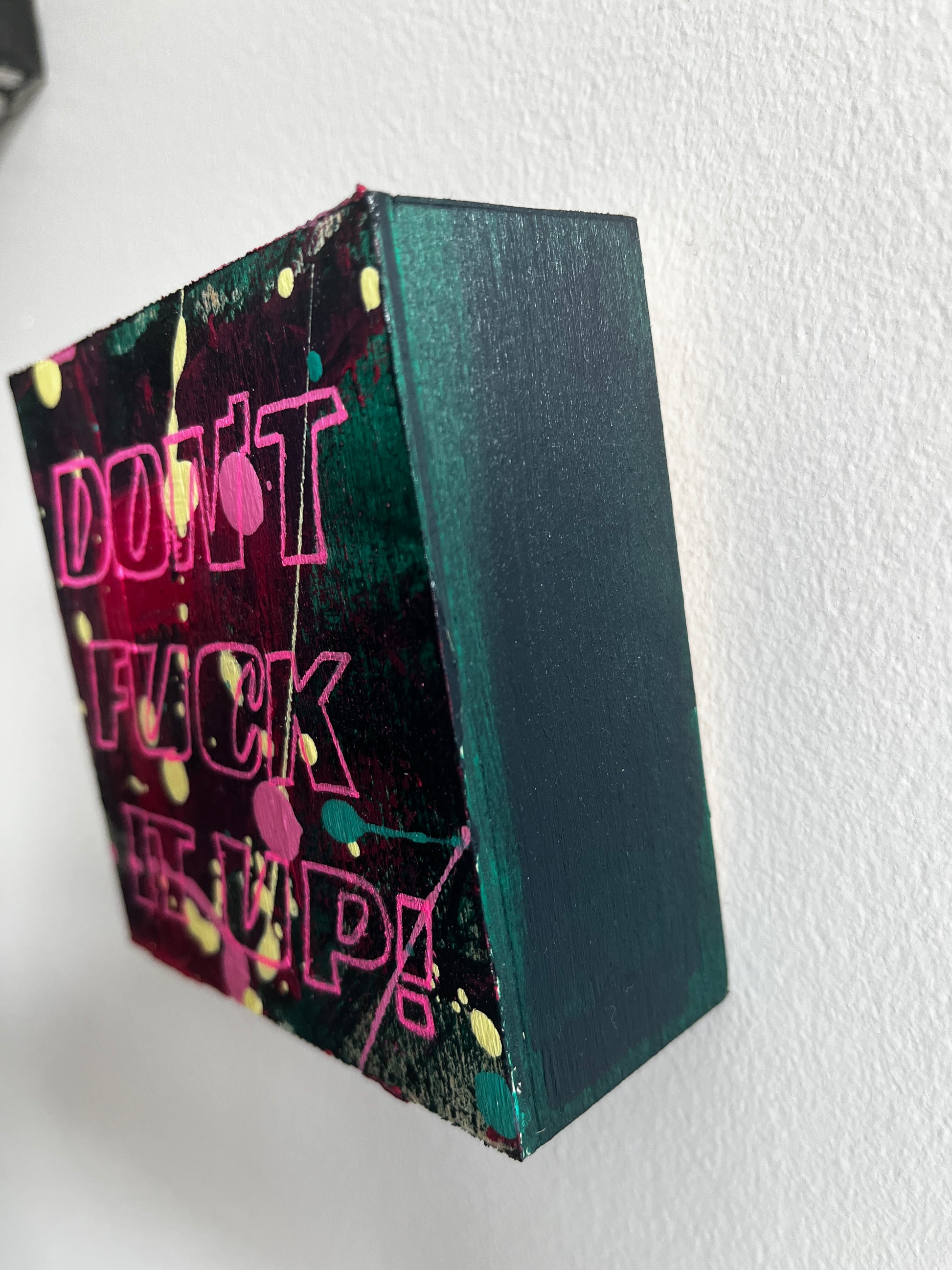 Black box with colorful text on a white background