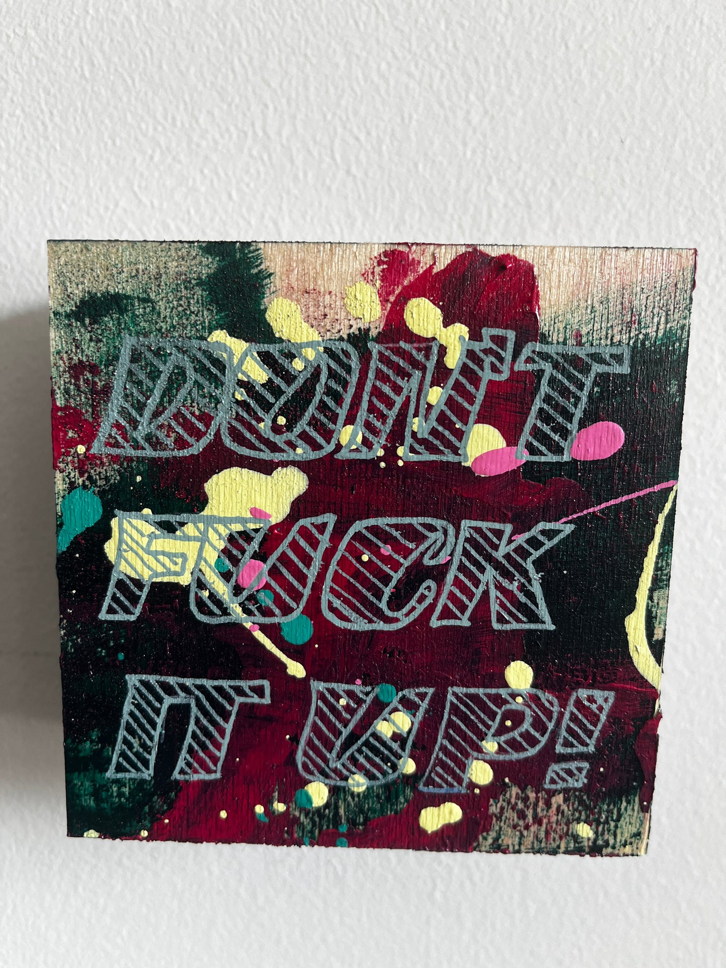 Abstract art piece with colorful patterns on a textured white background