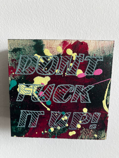Abstract art piece with colorful patterns on a textured white background