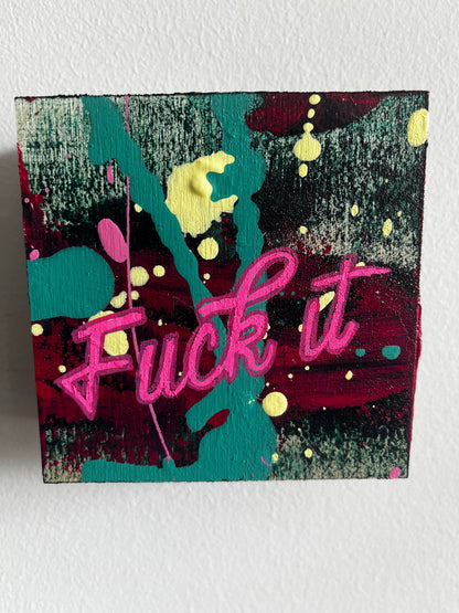 Abstract artwork with pink text and colorful splashes on a textured surface
