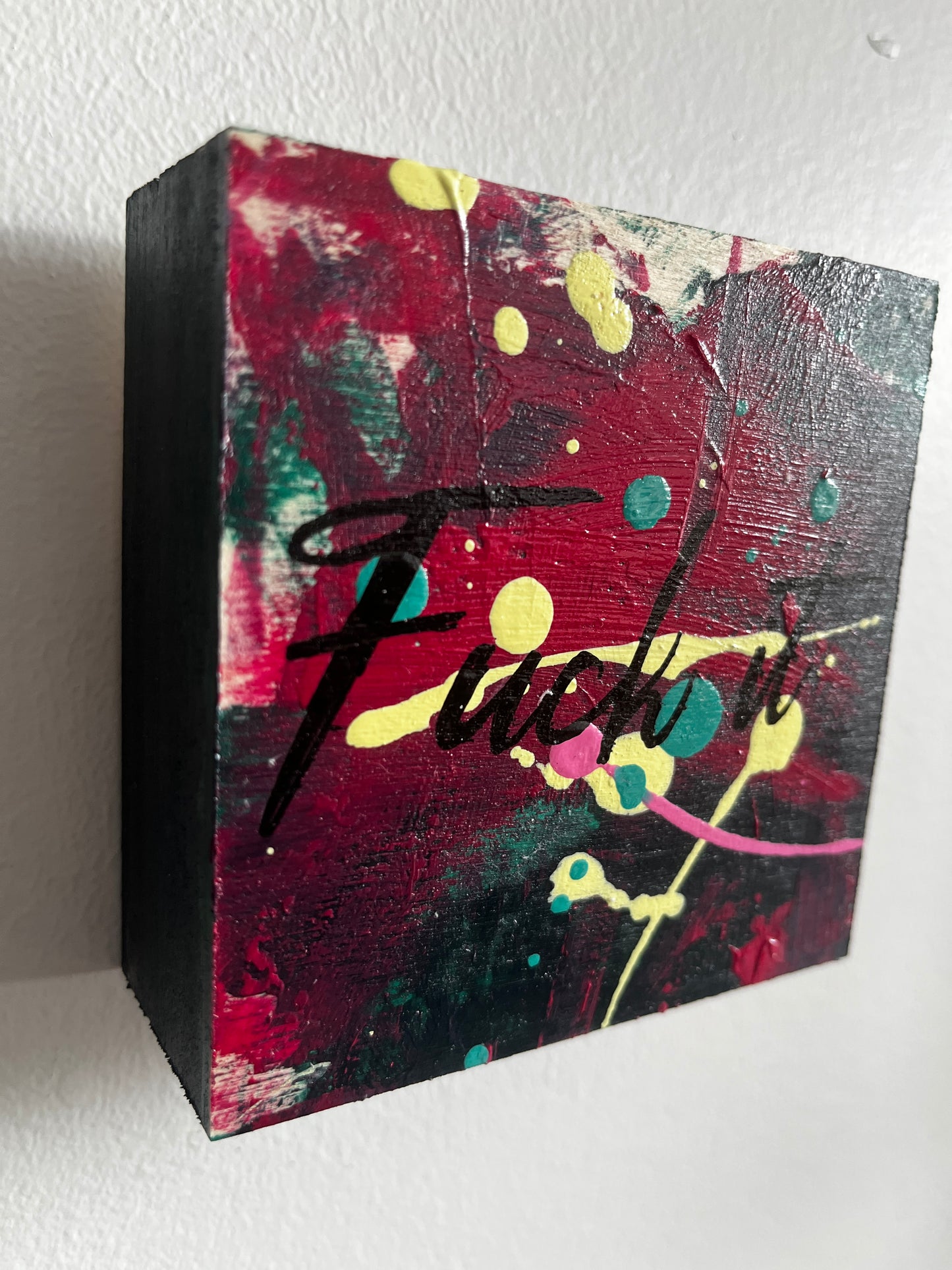 Abstract art piece with splashes of color on a white background