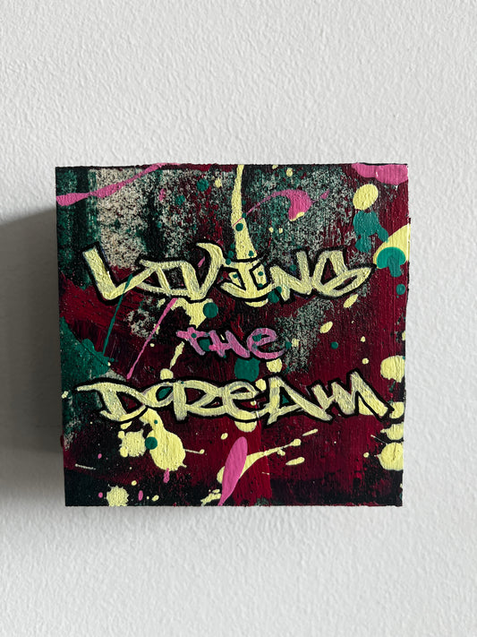 Abstract artwork with colorful splashes and text on a textured white background