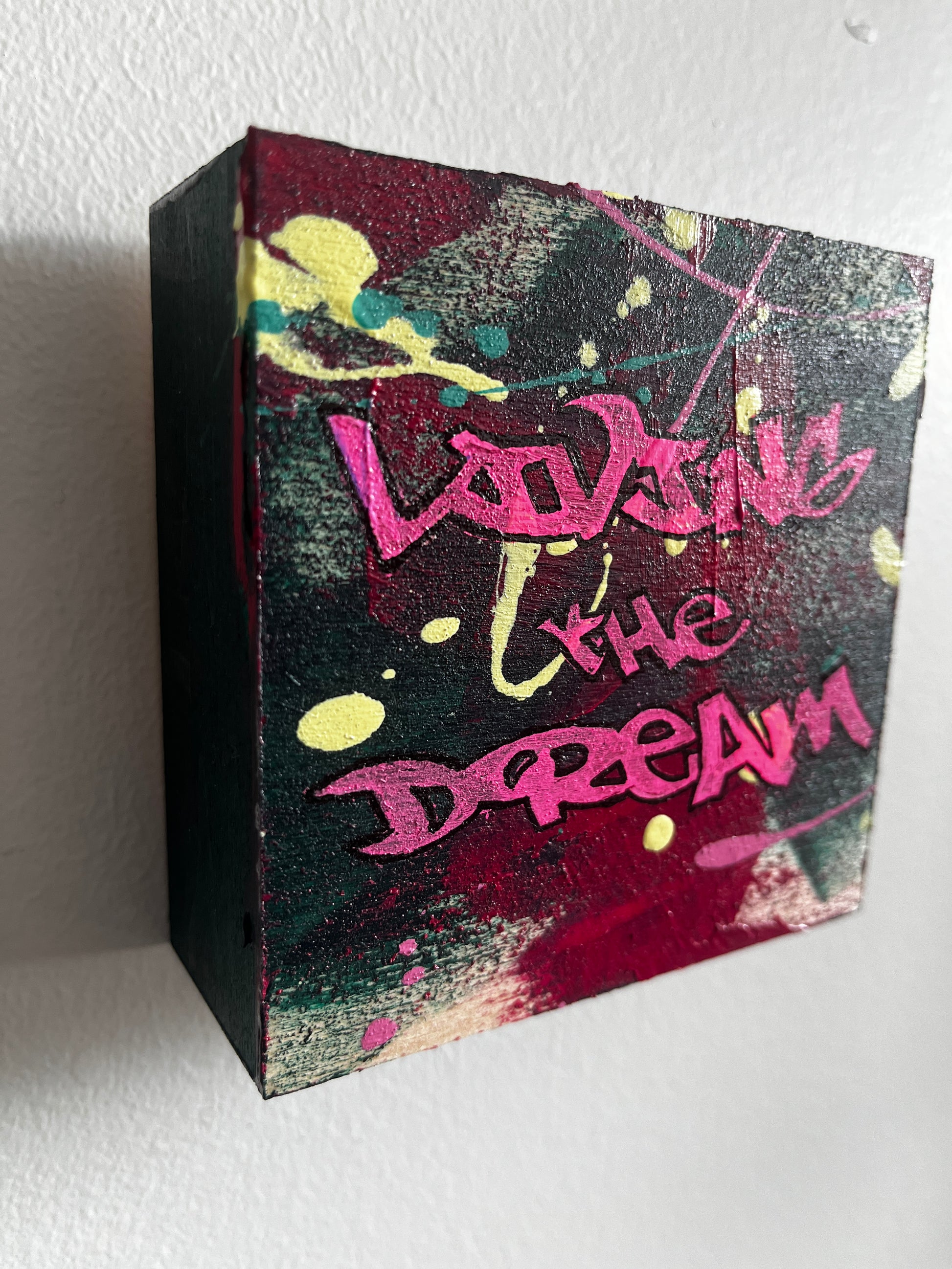 Colorful box with graffiti-style text on a white background
