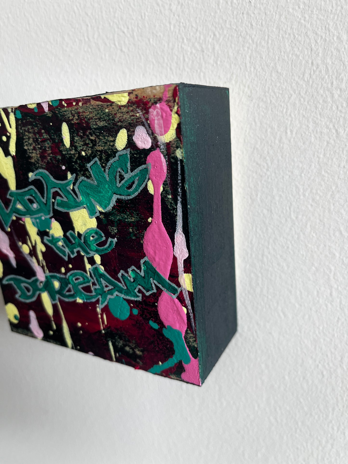 Colorful rectangular box with abstract design and text on a white background