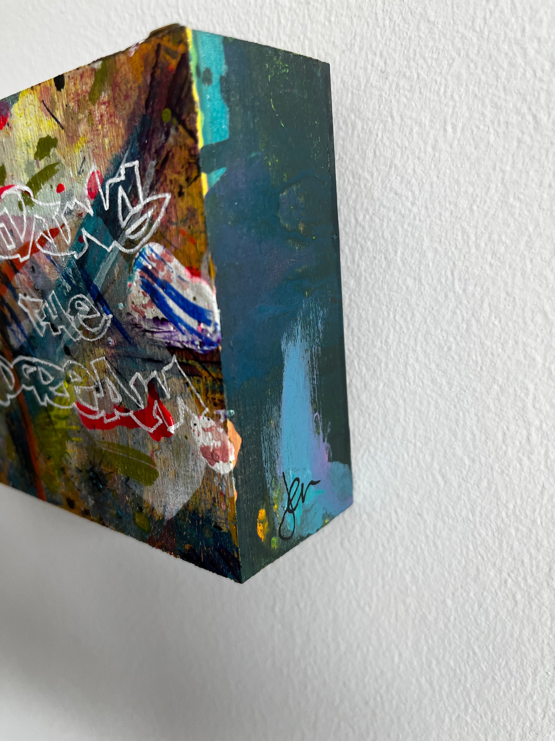 Abstract art piece on a textured white wall