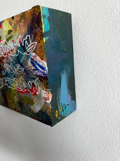 Abstract art piece on a textured white wall