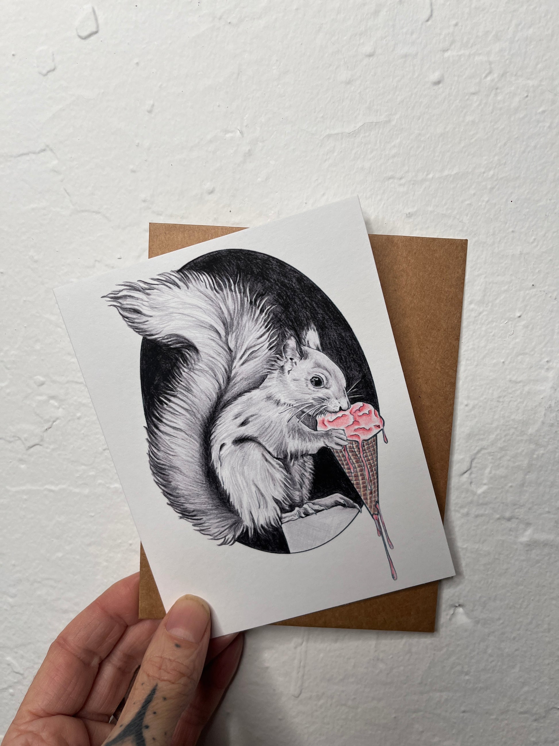 Card with a black and white illustration of a squirrel on a white background