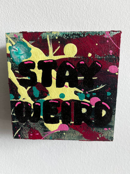 Abstract art piece with black text "Stay Weird" on a colourful background