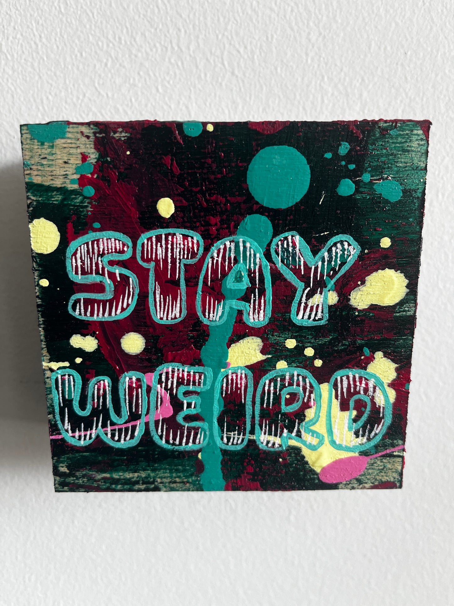Colorful abstract artwork with text on a textured surface
