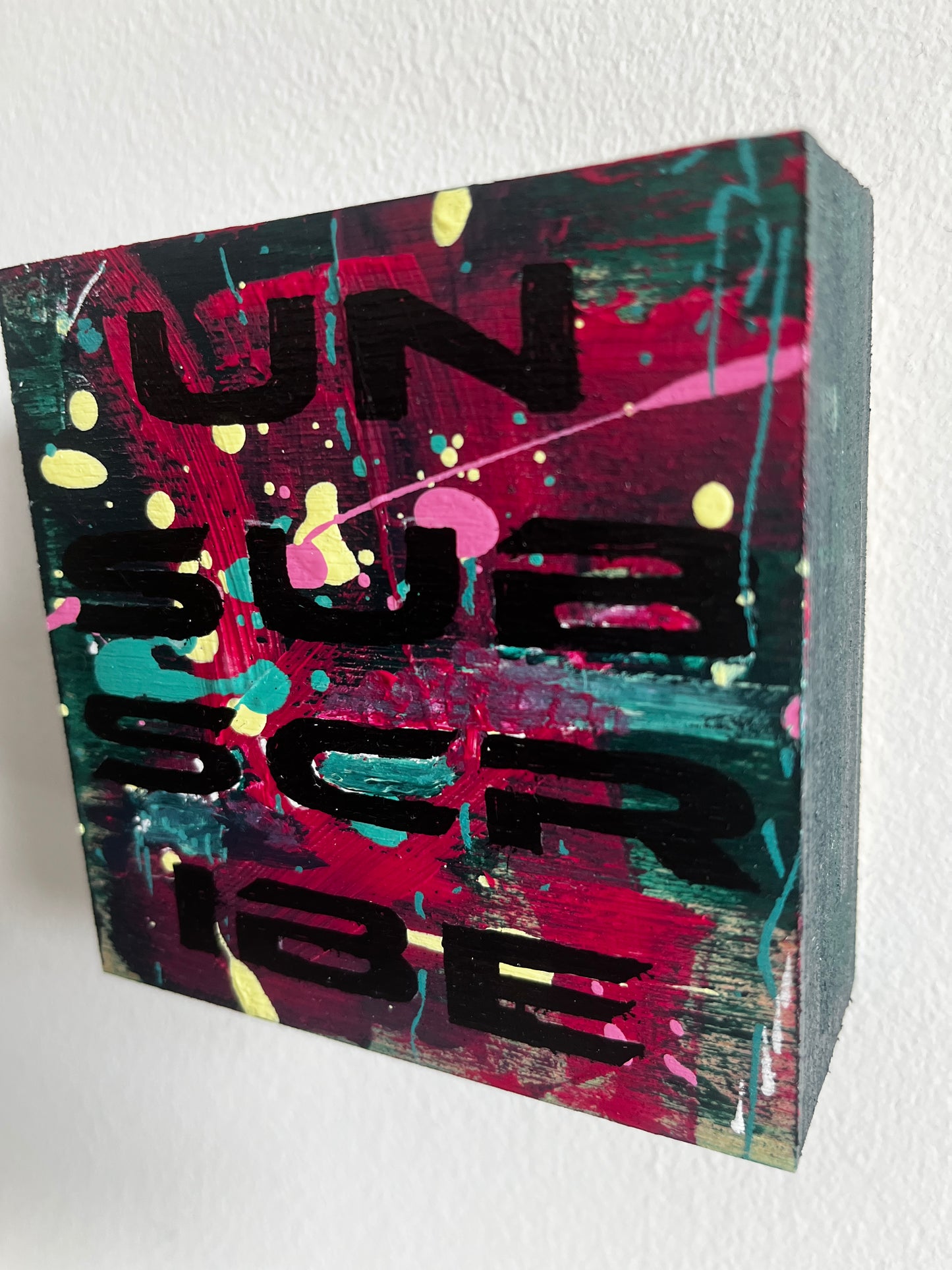 Colorful abstract art block with black text on a white background