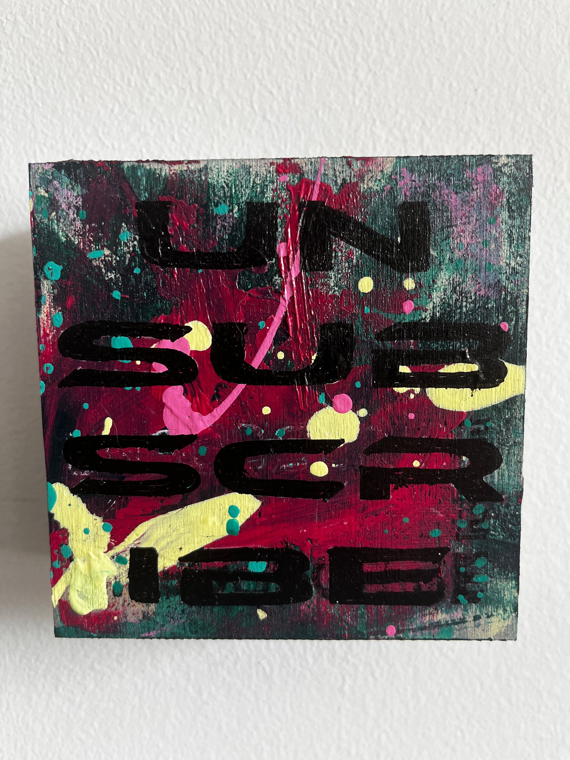 Abstract artwork with colorful text on a white background