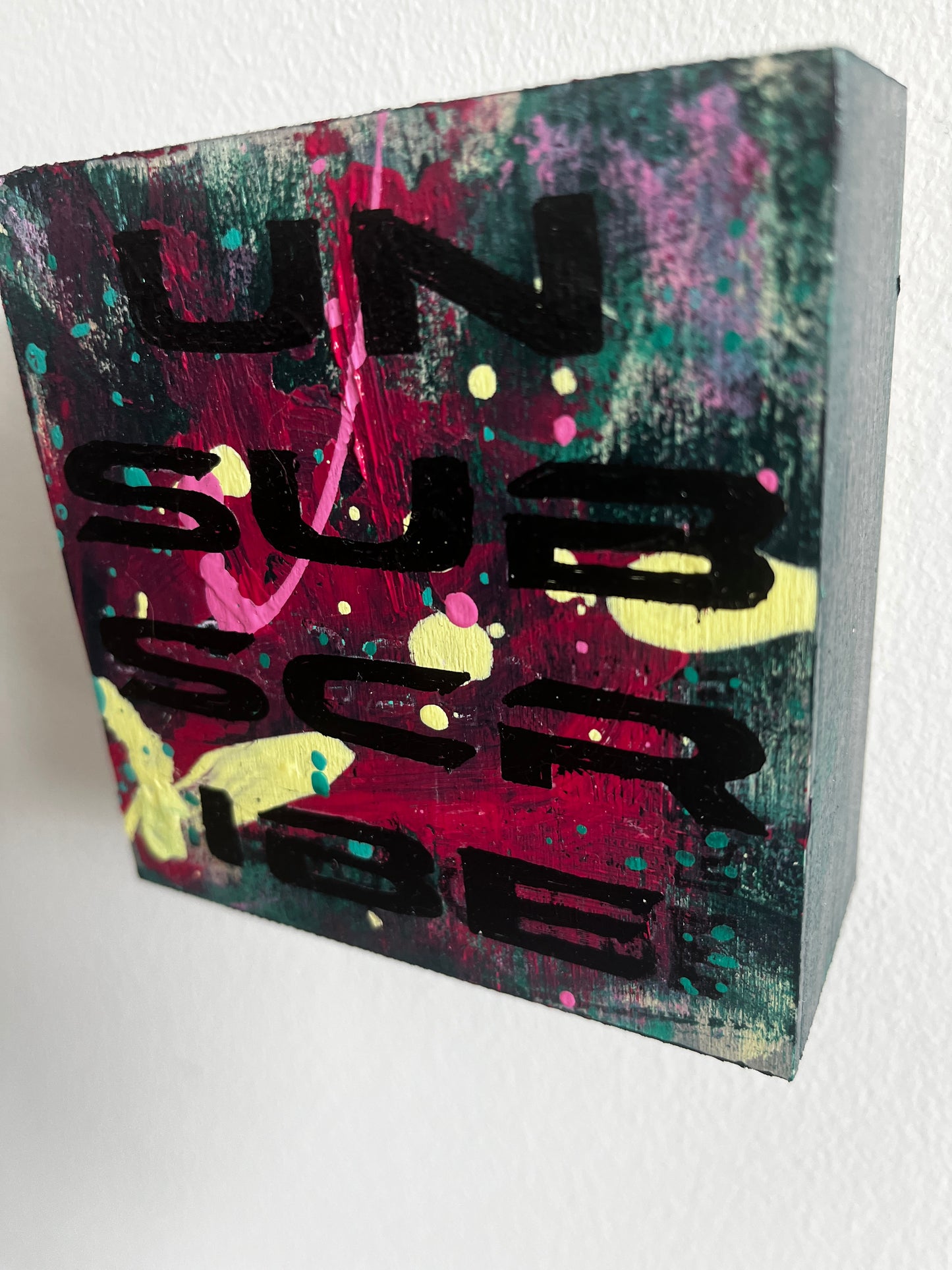 Colorful abstract art block with black text on a white background