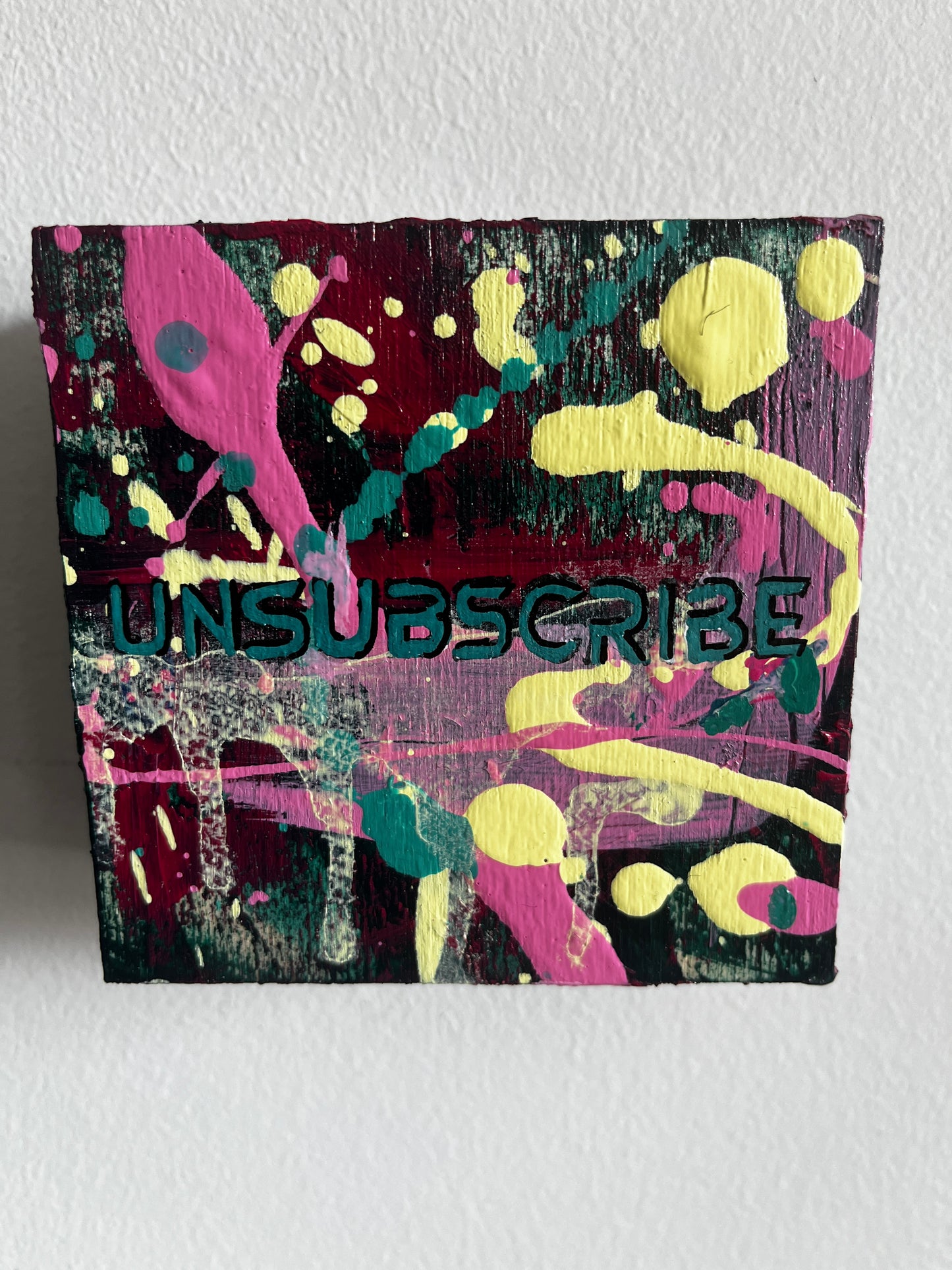 Colorful abstract painting with 'Unsubscribe' text on a white background
