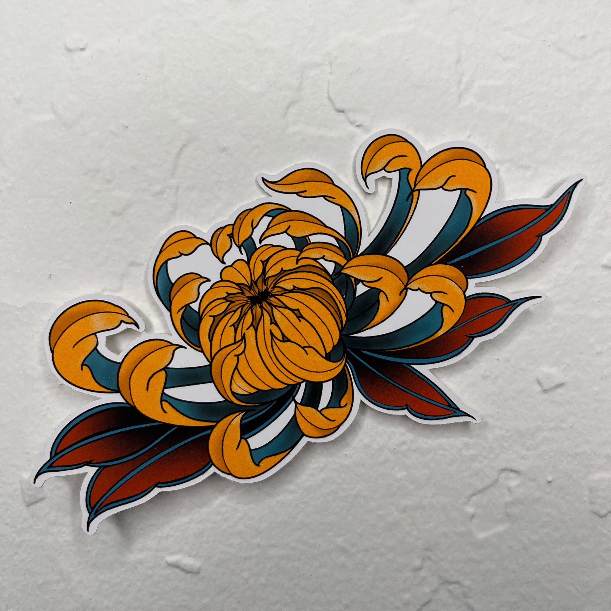 Decorative sticker with a floral design in orange, blue, and red on a textured white background