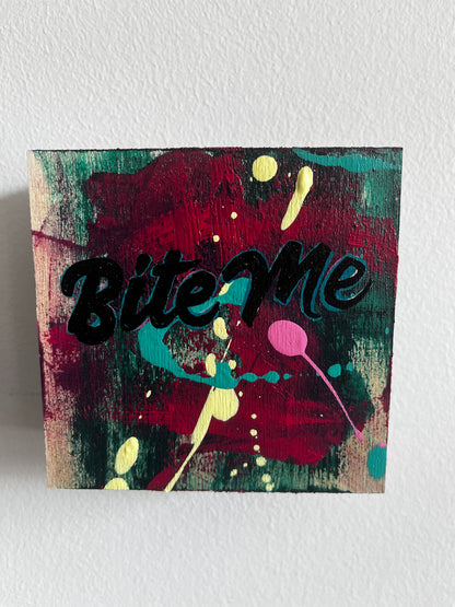 Colorful abstract painting with the word 'Bite Me' on a textured white background