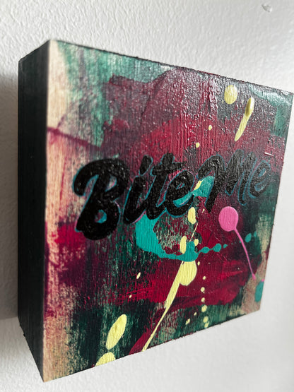 Abstract art piece on a square canvas with splashes of color and a black silhouette.