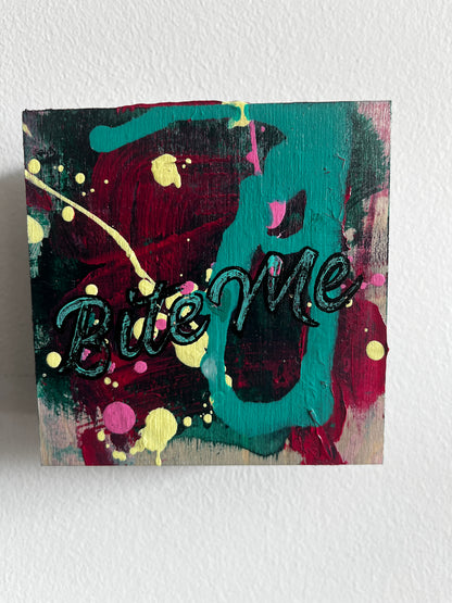 Abstract painting with text on a textured white wall