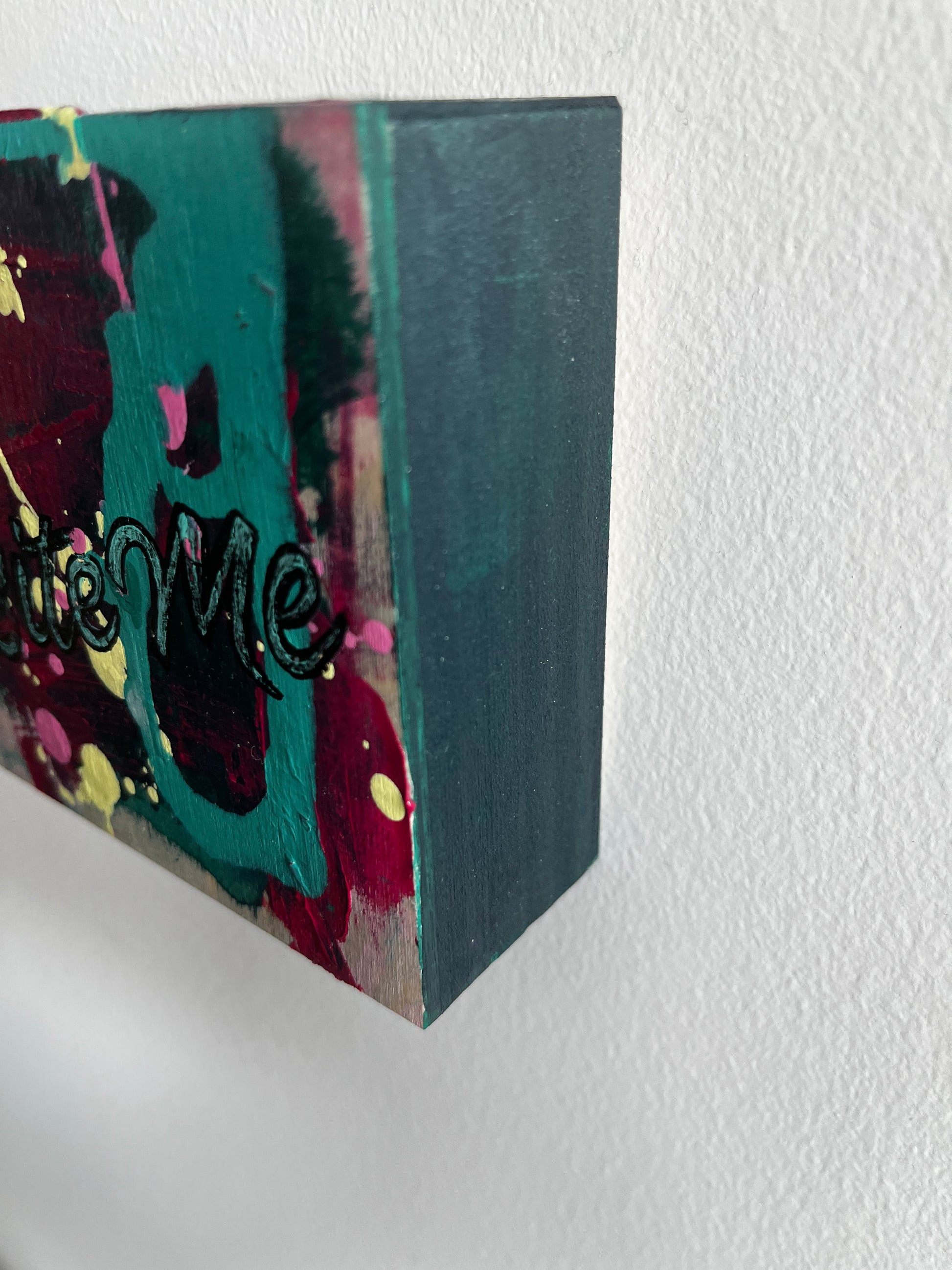 Colorful abstract painting on a textured white wall