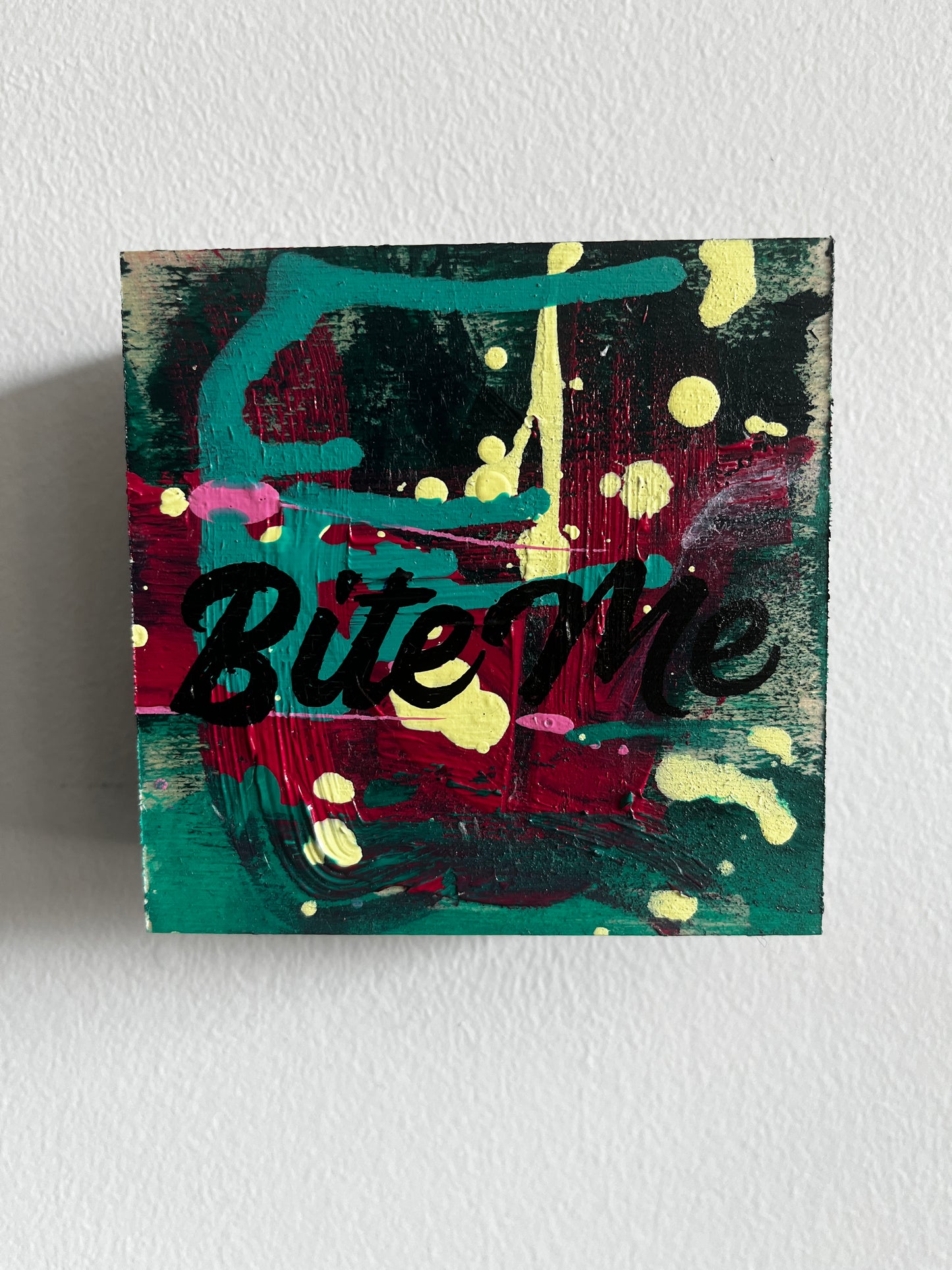 Abstract painting with splashes of color on a textured wall