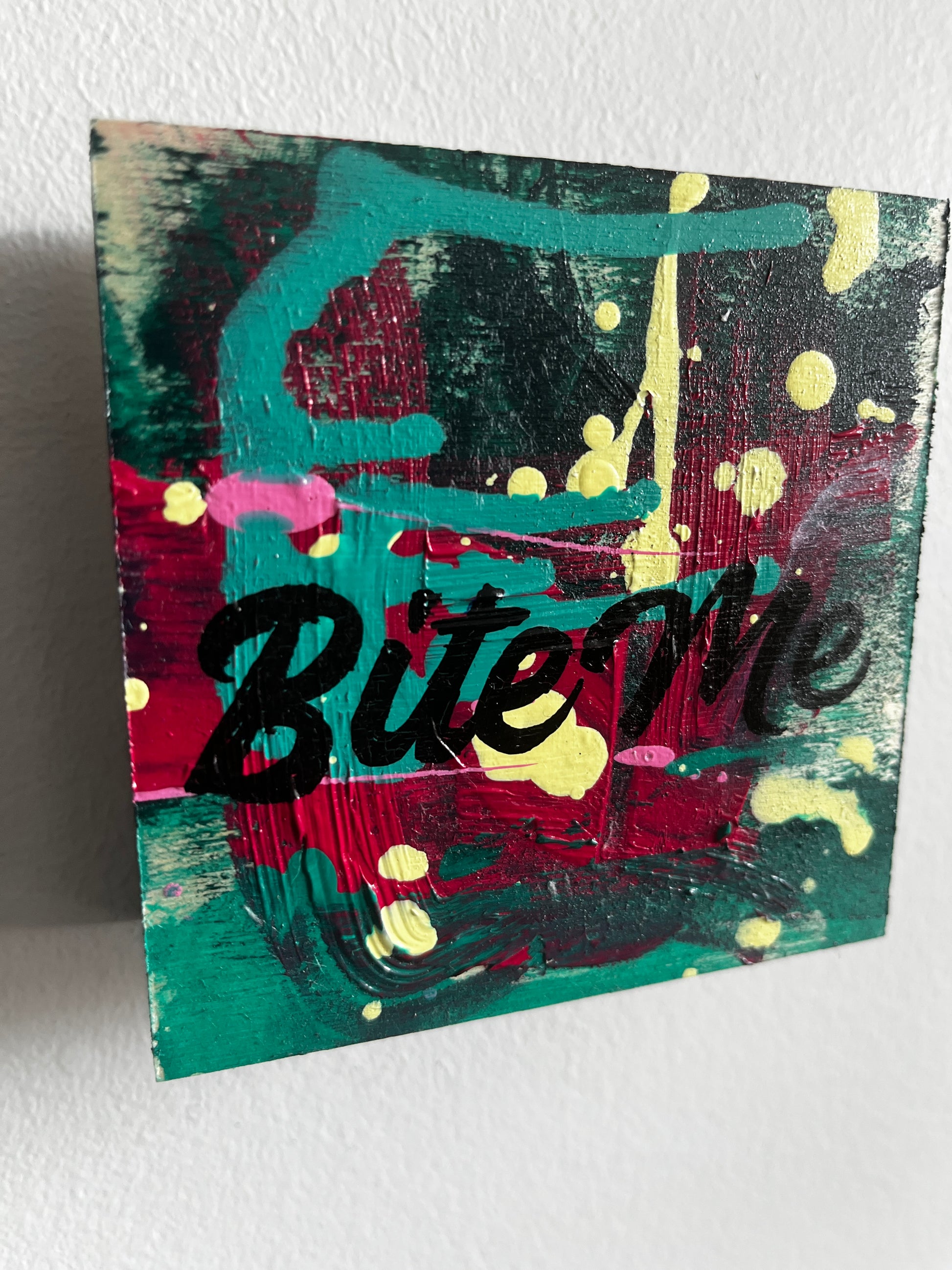 Abstract painting with colorful text on a white background