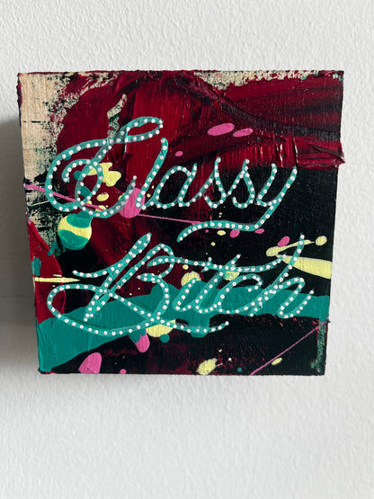 Abstract painting with colorful text on a textured surface