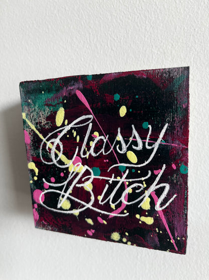 Canvas painting with colorful text and abstract patterns on a white background