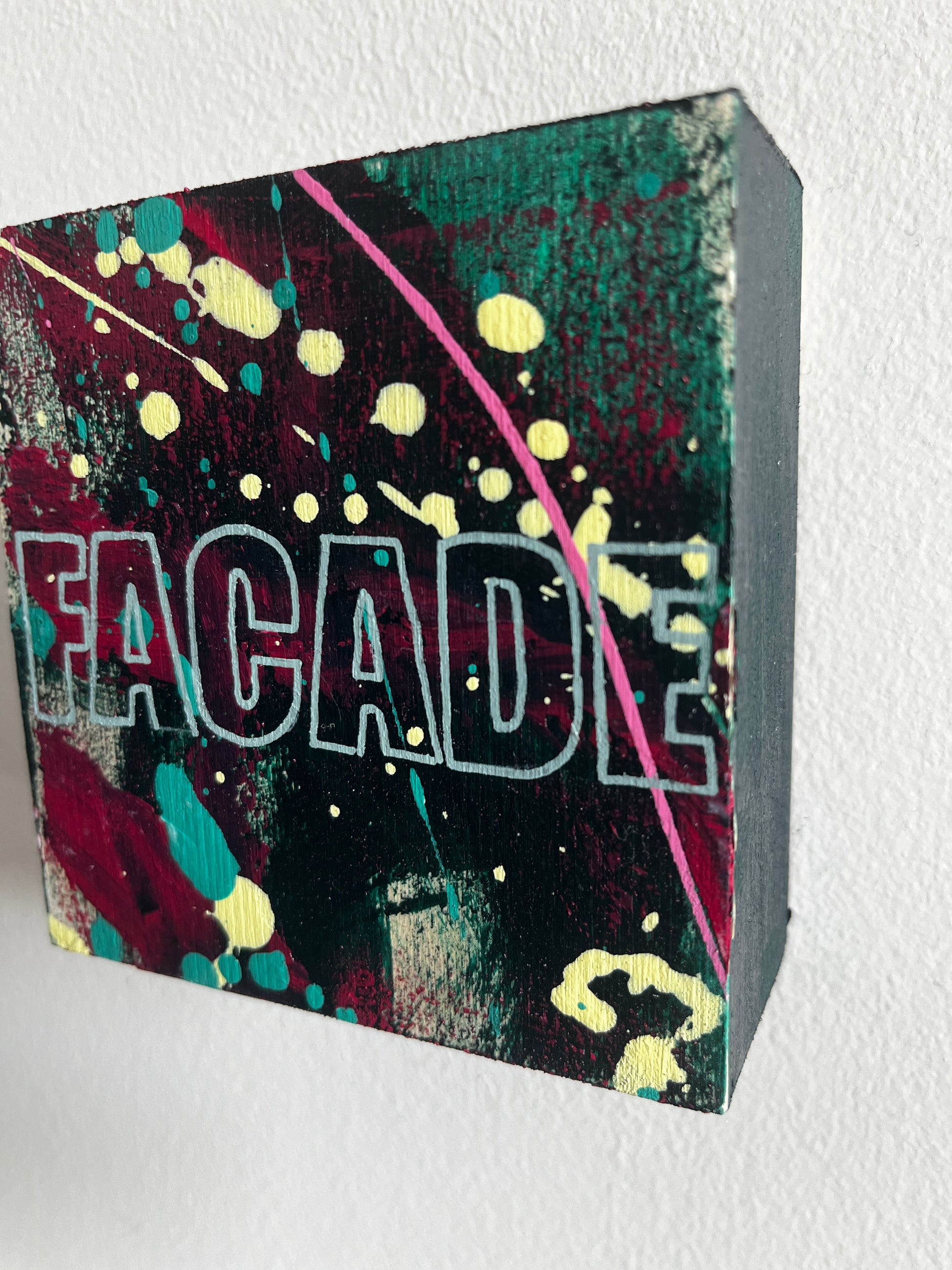 Colorful box with 'FACADE' branding on a white background