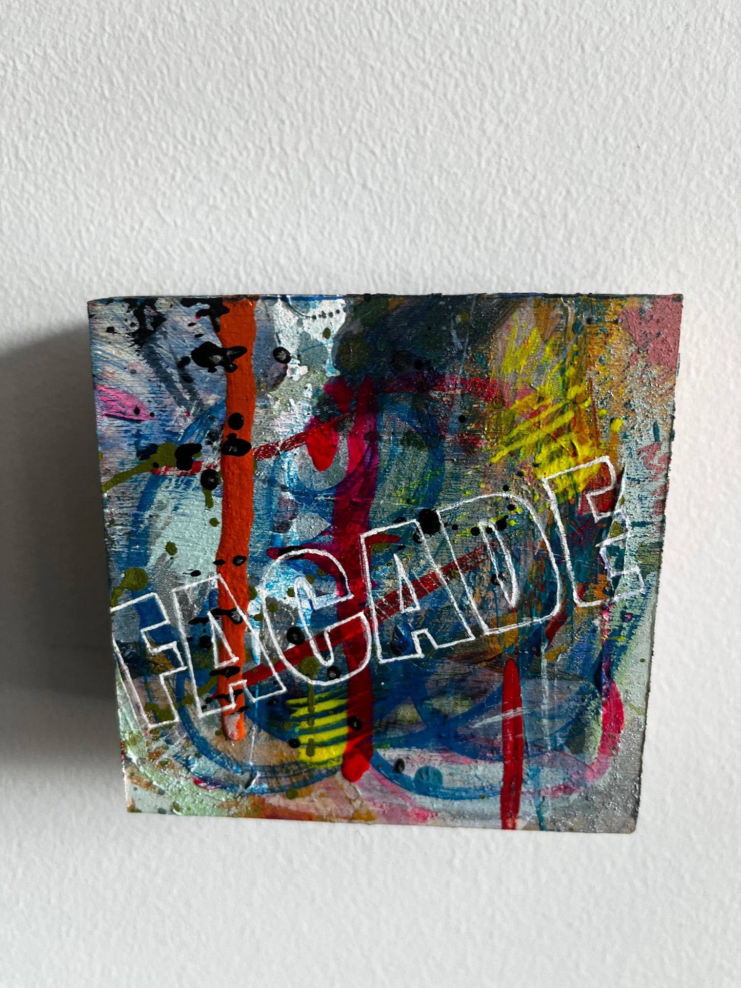 Abstract artwork on a textured white wall