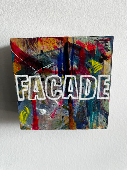 Abstract artwork with colorful patterns and 'FACADE' branding on a white wall.