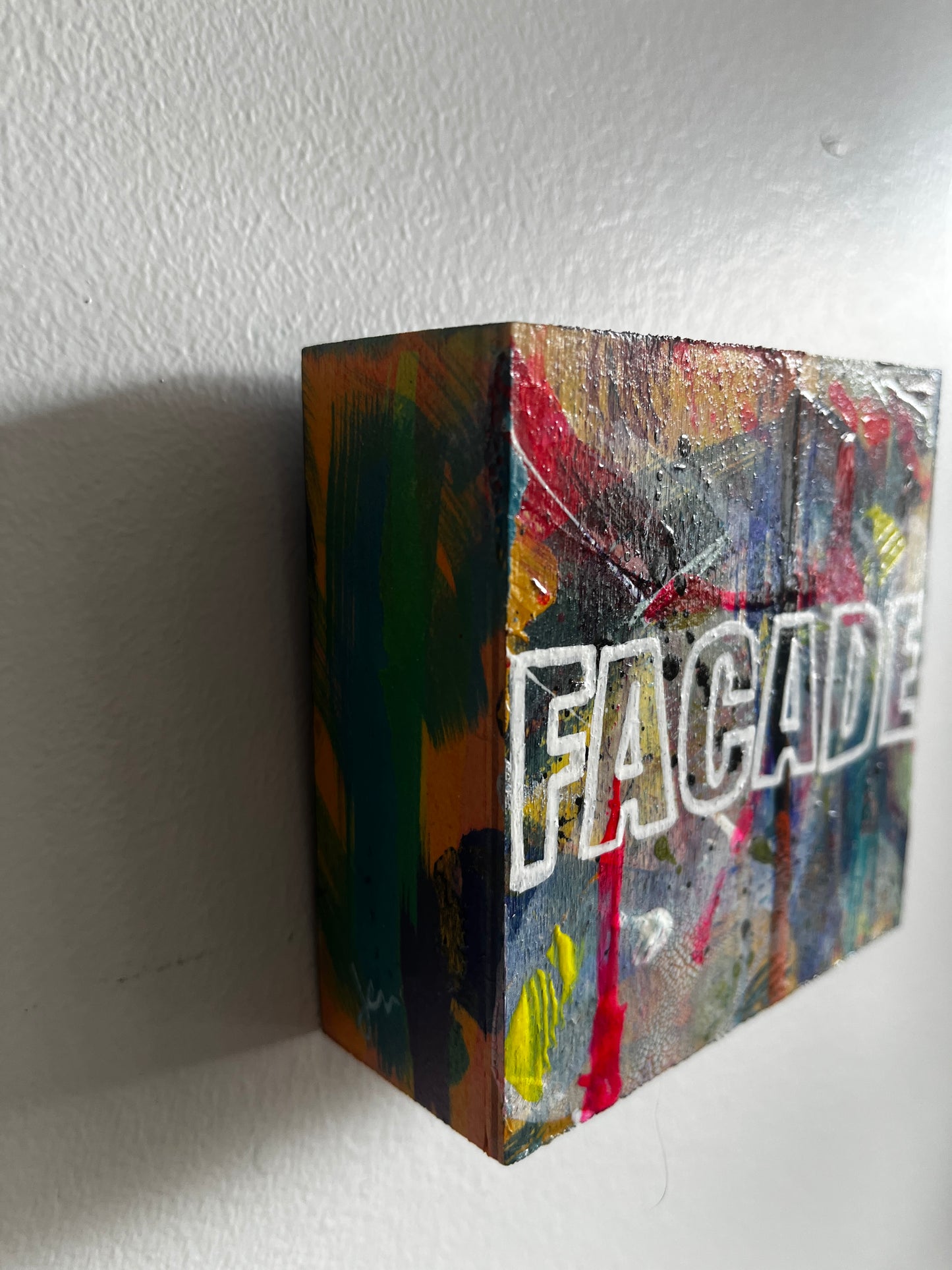 Colorful box with 'Facade' branding on a white surface