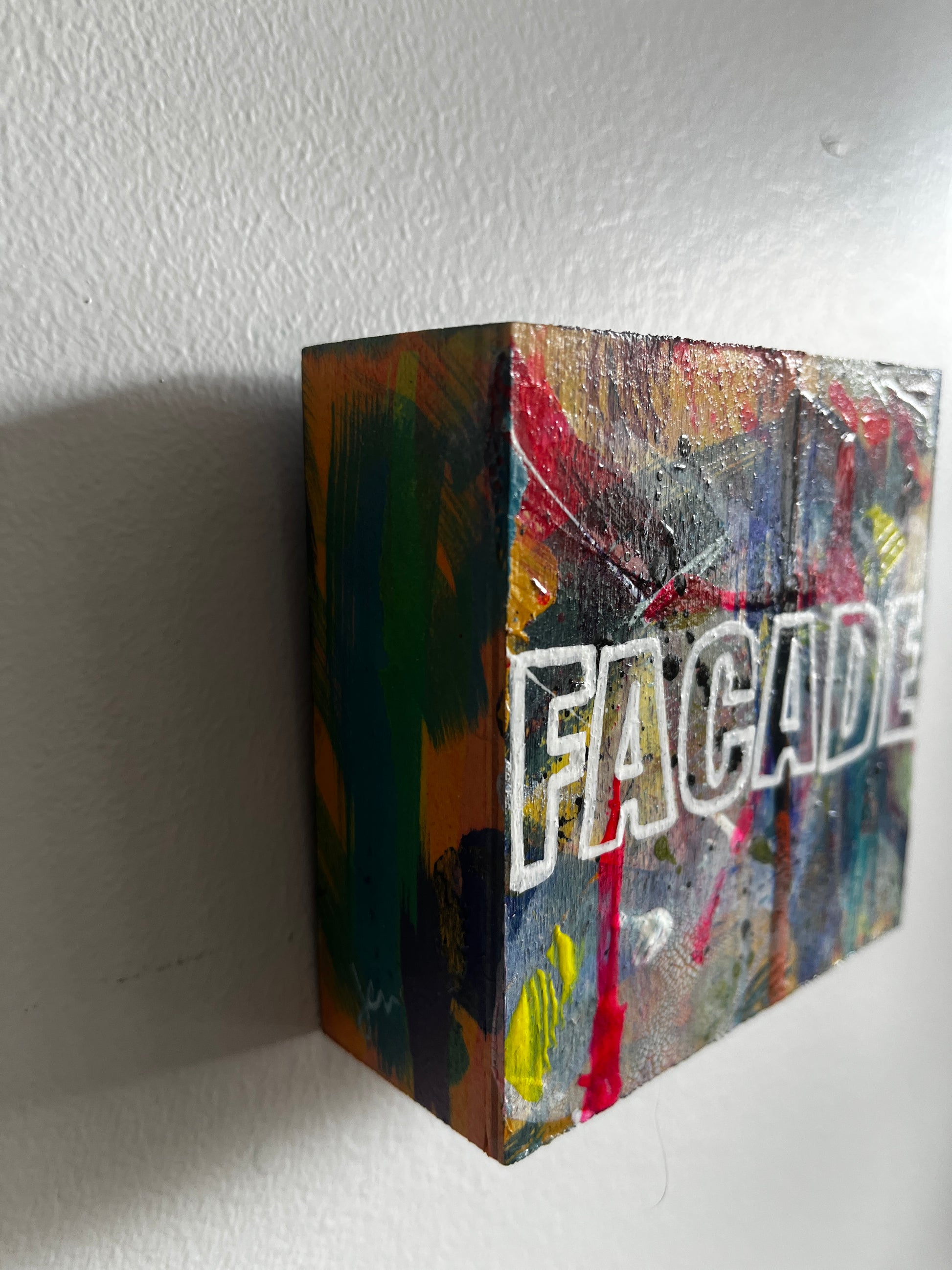 Colorful box with 'Facade' branding on a white surface
