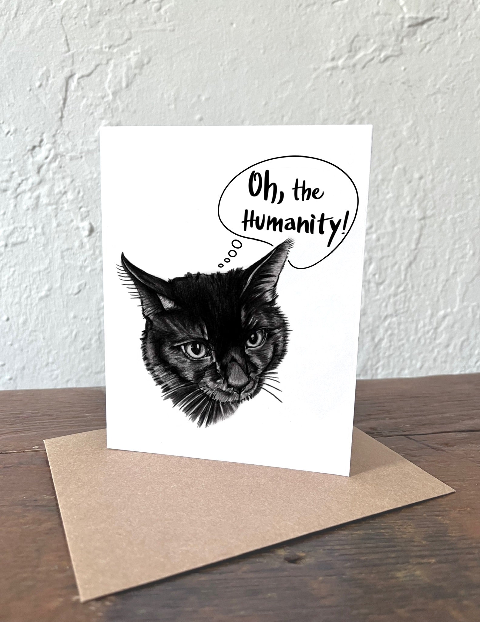 Greeting card with a black cat illustration and 'Oh, the Humanity!' text on a white background.