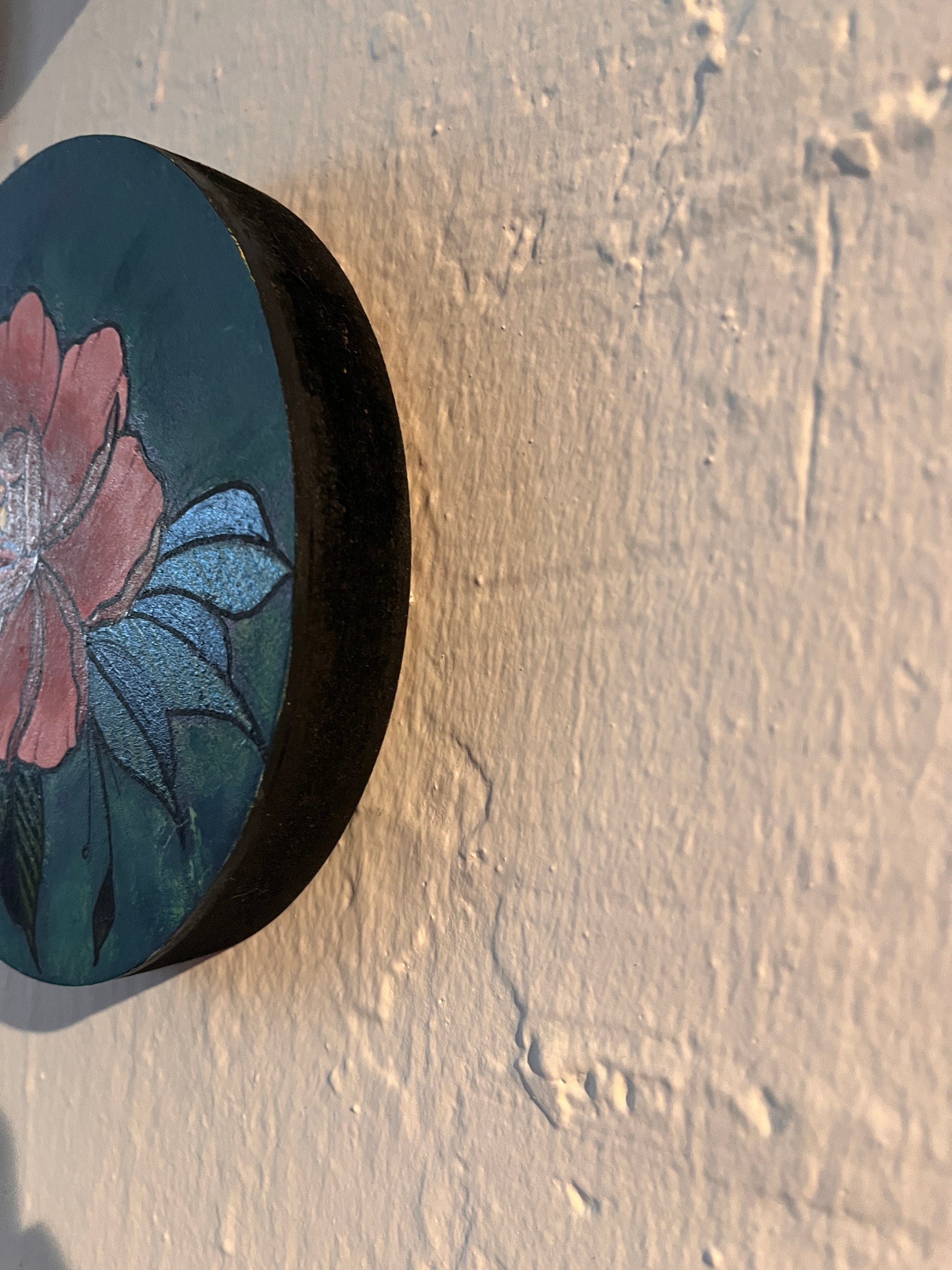 Side view with floral design painted on a wooden surface